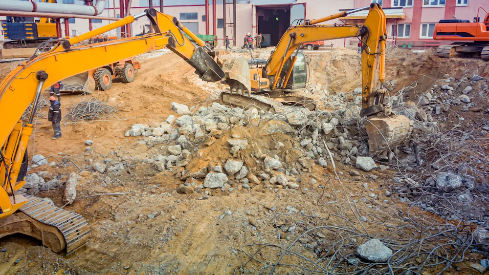 Excavators working on a large industrial demolition site